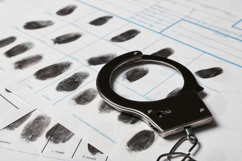 criminal record with finger prints and handcuffs for an expunction or nondisclosure