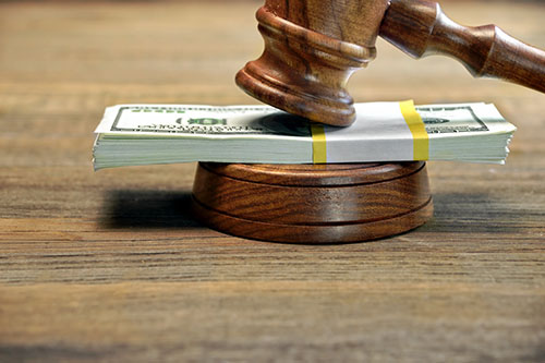 judge's gavel with stack of money in bankruptcy court