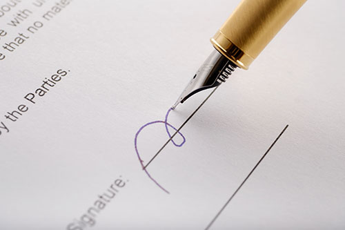 golden fountain pen signing an employment contract